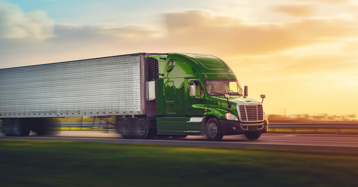 green-semi-truck-highway-blurred-1200x628