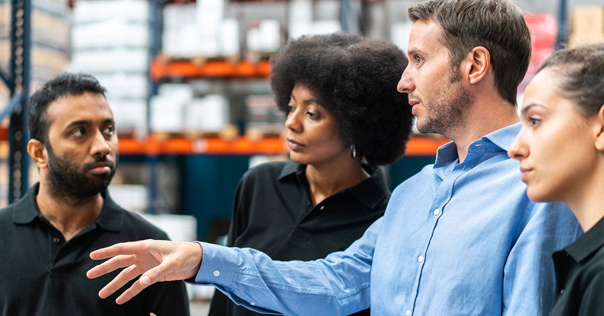 warehouse-supervisor-discussing-with-team-1200x628